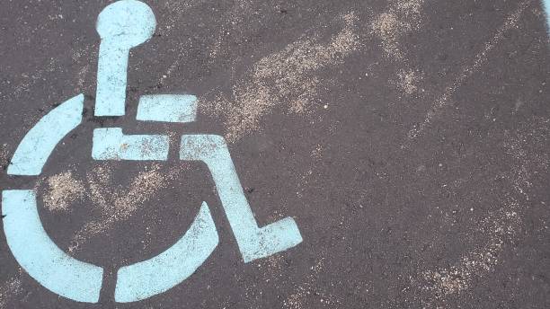 istock Faded handicap symbol on dark pavement 1438743009