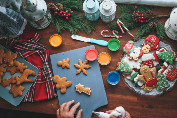 istock Decorating Gingerbread Christmas Cookies with Icing 1438745135