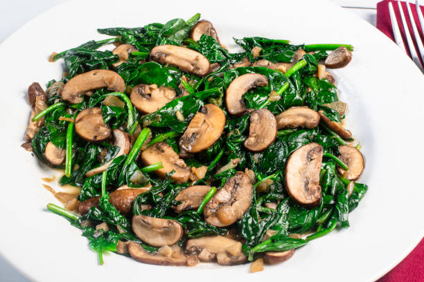 istock plate of sauteed spinach and mushrooms, 1438753099