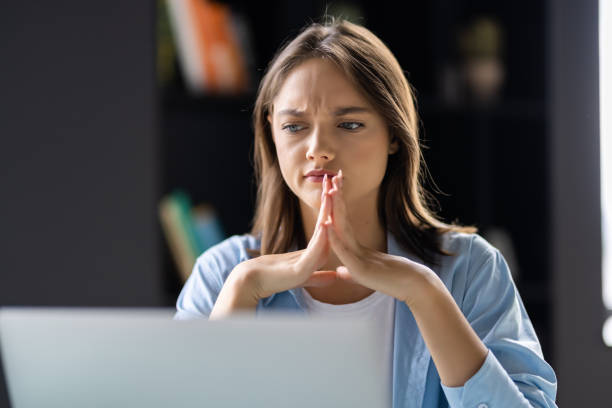 istock Beautiful woman thinking while sitting at table in office 1438753542