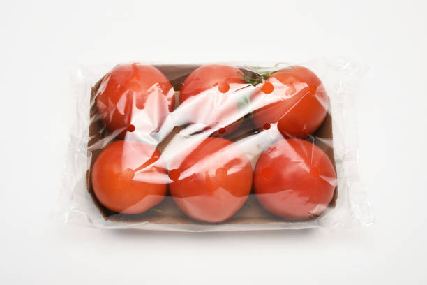 Stale tomstoes in a plastic box. Wasting food.