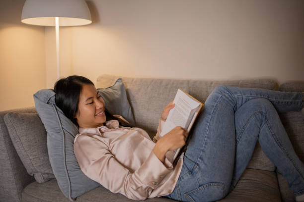 istock Woman relaxing and reading a book 1438756715