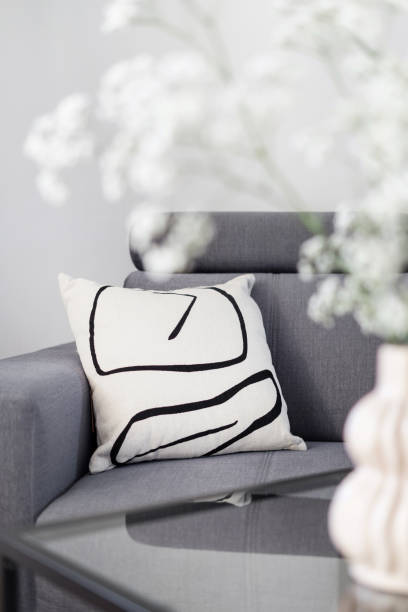 istock grey couch, pillows and flowers in living room 1438756947