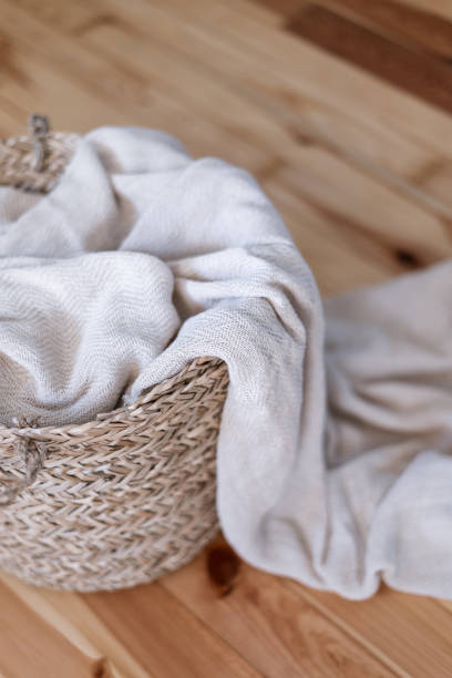 istock soft plaid in wicker basket on wooden floor 1438756948