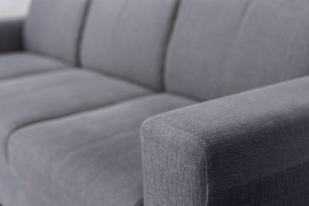 selective focus on upholstery of grey sofa stock photo