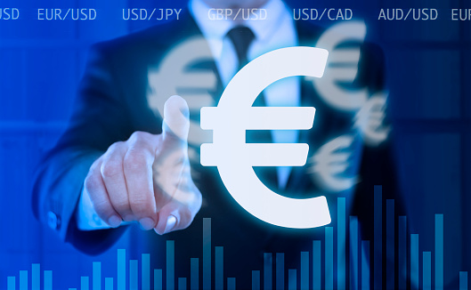 businessman touching a virtual screen with Euro currency symbols