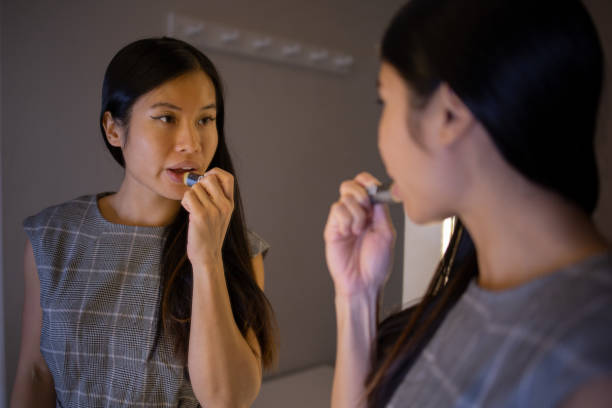 istock Handsome woman applying moisturizer to his face 1438760523