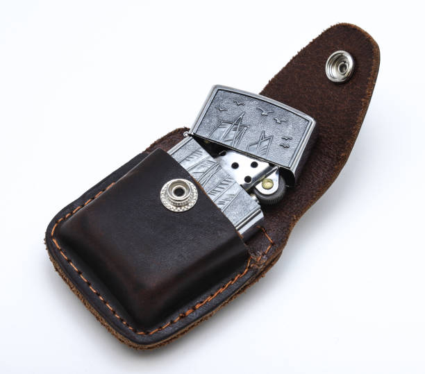 istock Old-fashioned gasoline lighter with a leather case on a white background. Close-up 1438764867
