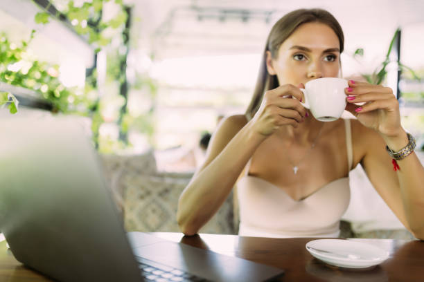istock Businesswoman having a coffee while working from a cafe. 1438767609
