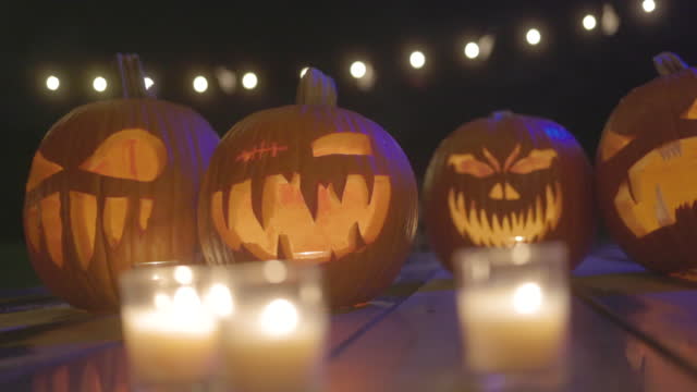 Jack O'Lanterns - Carved Pumpkins - Scary Halloween Decorations - Lanterns - Candles - Many Pumpkins Close Up