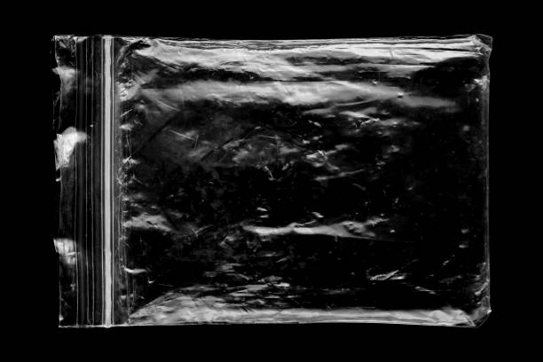 istock Blank transparent plastic bag overlay on black background 1438774189