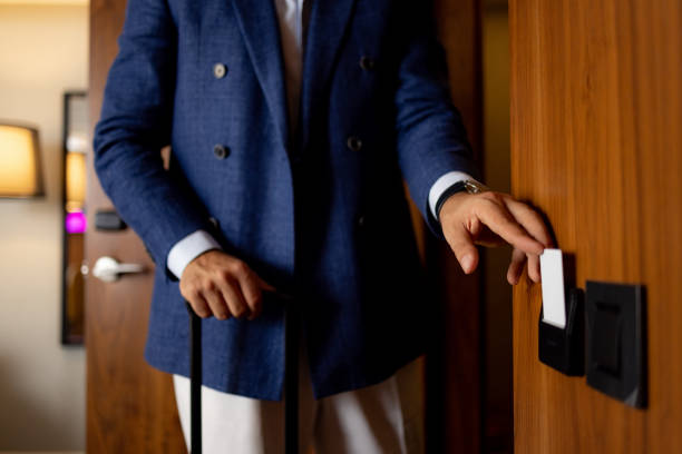 istock Elegant man unlocking hotel room door with key card 1438774444