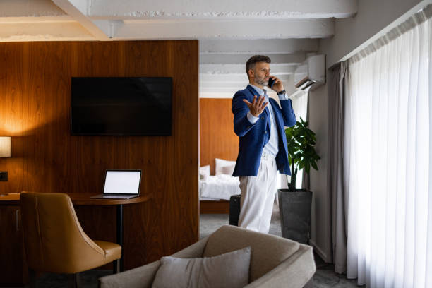 istock Happy businessman holding mobile phone enjoying conversation with his client 1438774450