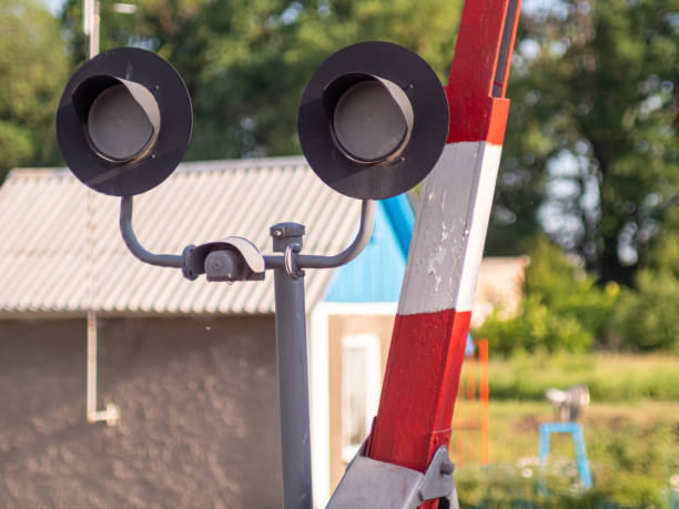 istock Railway traffic light and barrier at the railway crossing, close-up with selective focus. Strict enforcement of traffic rules concept. Do not ignore safety rules on the road 1438774595