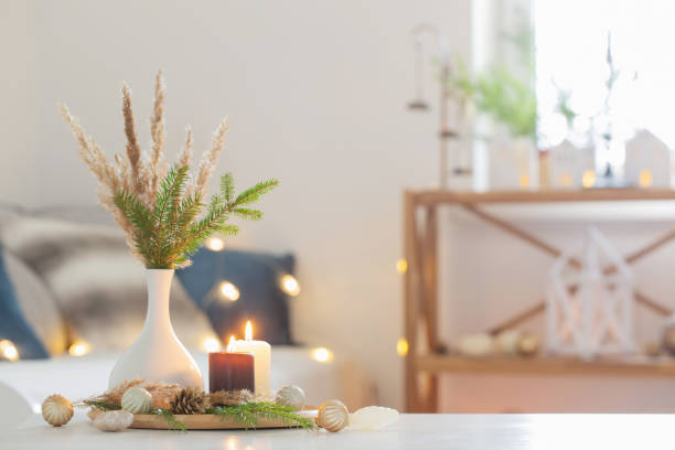 istock burning candles with christmas decor in white cozy interior 1438775161