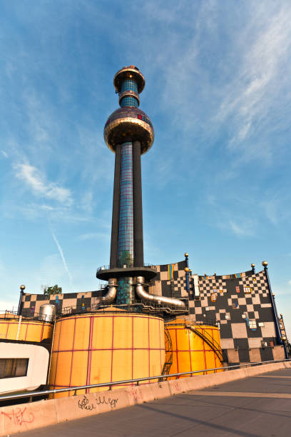 District heating Vienna of Hundertwasser forms Vienna, Austria - July 22, 2009: Chimney of the most famous District heating in Vienna of artist Hundertwasser in intensive afternoon light  in Vienna, Austria. hundertwasser haus in vienna austria stock pictures, royalty-free photos & images