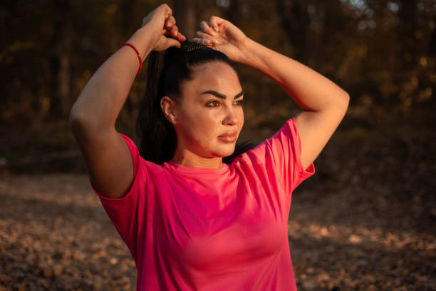 istock Young woman ties her hair, preparing for training 1438782132