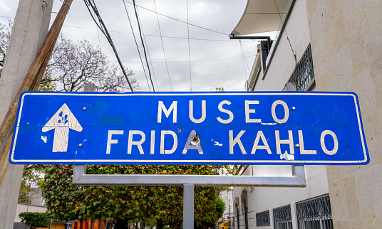 Mexico City Mexico - February 12 2022: A sign directing pedestrians to the Frida Kahlo Museum with a bullet hole in it in Mexico City