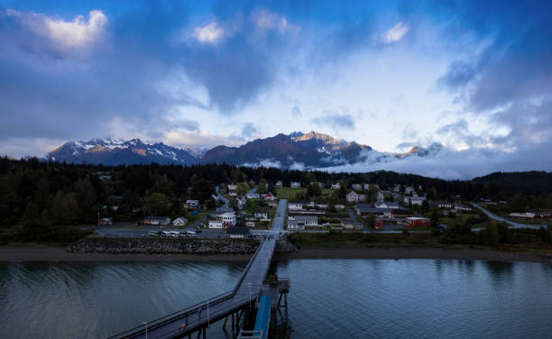 panoramic view of alaskan haines town with scenic sunset and dramatic ocean in the background - haines imagens e fotografias de stock