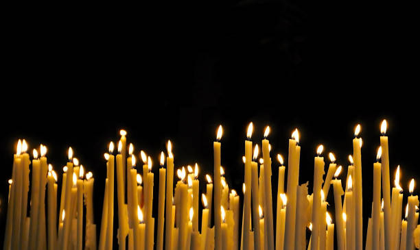 istock Candles of remembrance on black background 1438798224