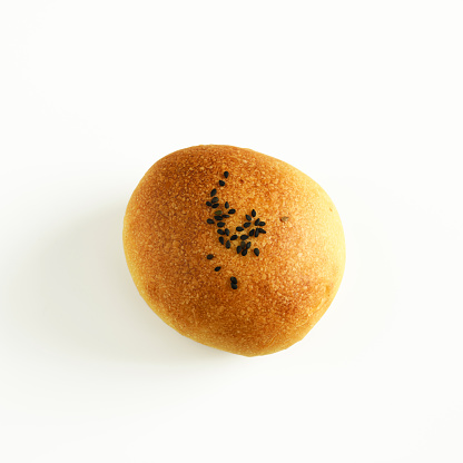 Close-up of round bread with sesame, isolated on white with clipping path.
Anpan.