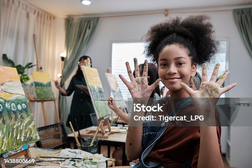 istock Black girl's hand messed up with acrylic colors, happy learning in art studio. 1438800669