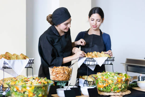 istock Cook teaching another cook how to arrange the buffet food 1438803335