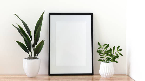 istock A picture frame on the floor with a flower vase. 1438804005