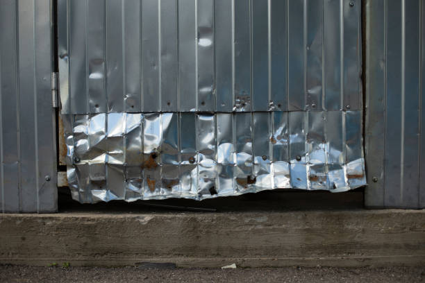 Crumpled metal. Broken door. Steel profile broken. stock photo