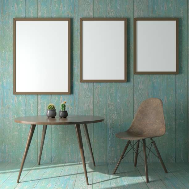 Picture frame attached to the wall, with chairs and vases placed on the table.