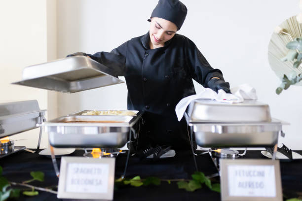 istock Cook uncovering the buffet trays 1438807267