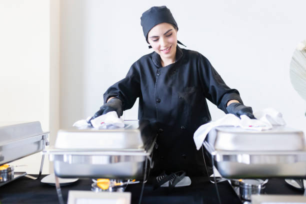 istock Cooking with hands on the lids of the buffet trays 1438807375