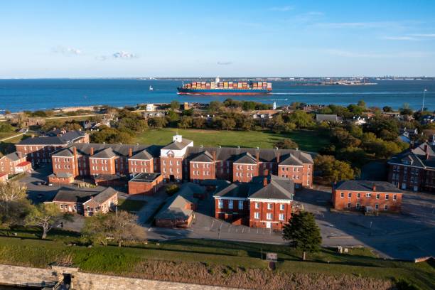 Aerial view of Fort Monroe as a container ship passes by in the Chesapeake Bay Hampton Virginia - April 17 2022: Aerial view of Fort Monroe as a container ship passes by in the Chesapeake Bay hampton virginia photos stock pictures, royalty-free photos & images