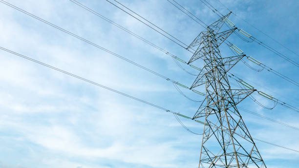 istock High voltage tower with electricity transmission power lines against blue sky. 1438809298