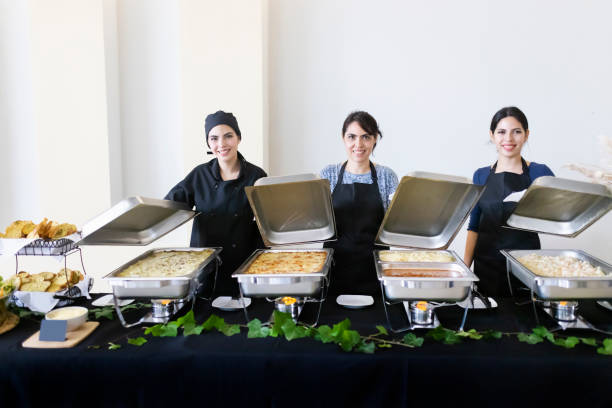 istock Cooks uncovering buffet trays 1438810077