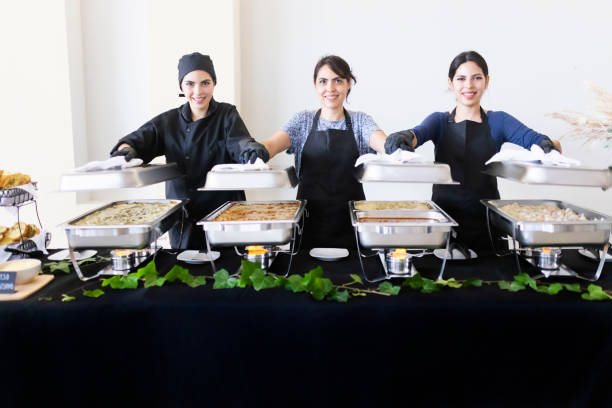 istock Cooks uncovering buffet trays 1438810297