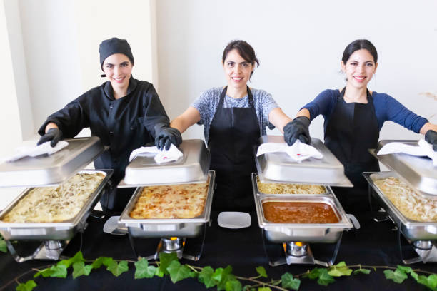 istock Cooks uncovering buffet trays 1438810325