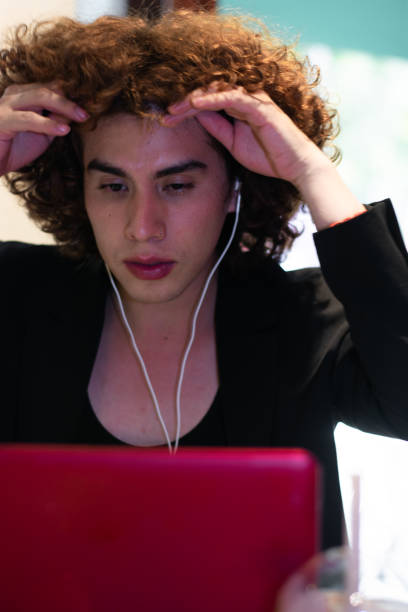 istock a non-binary person shows a worried expression in front of a laptop while working 1438812682