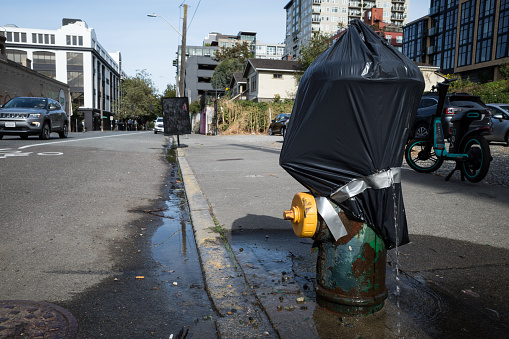 Seattle, USA - Sep 17th, 2022: A damaged duct taped fire hydrant in downtown on Western Ave.