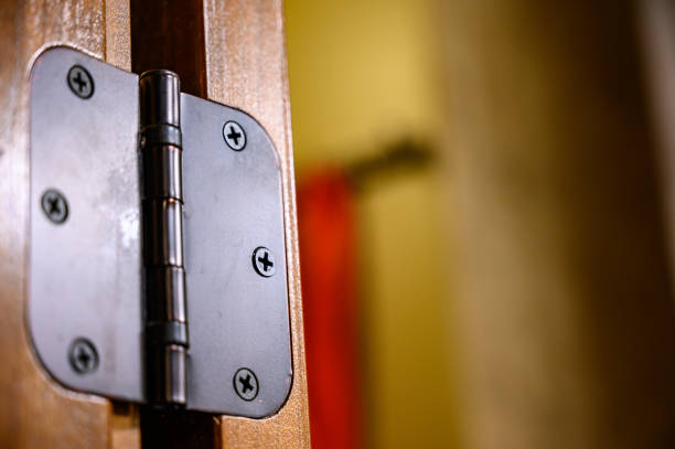 istock Selective focus on Oiled bronze door hinge on wood 1438817527
