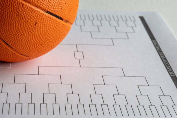 istock Blank bracket grid on white paper with basketball on top 1438817705
