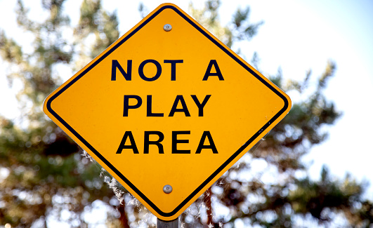 Yellow sign stating Not A Play Area