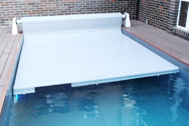 istock The protective covering for the pool which is rolled on a roller. Unique high-tech PVC lamellas 1438826792