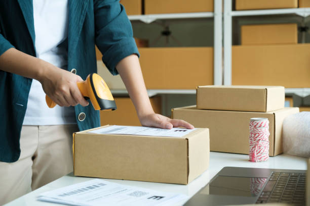 istock Young entrepreneur scanning online order box. 1438829357