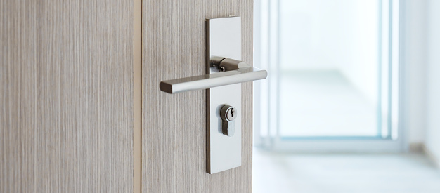 Closeup doorknob of wooden door between open or close the door