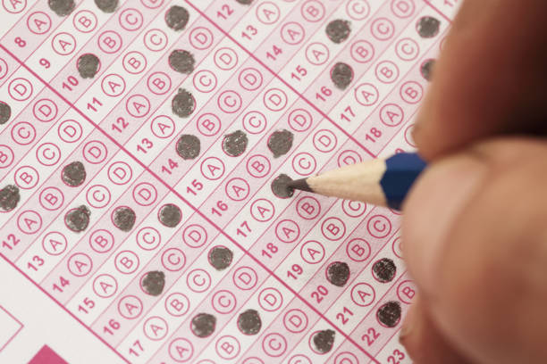 istock Education school test concept , Hand holding pencil for testing exams writing answer sheet 1438835773