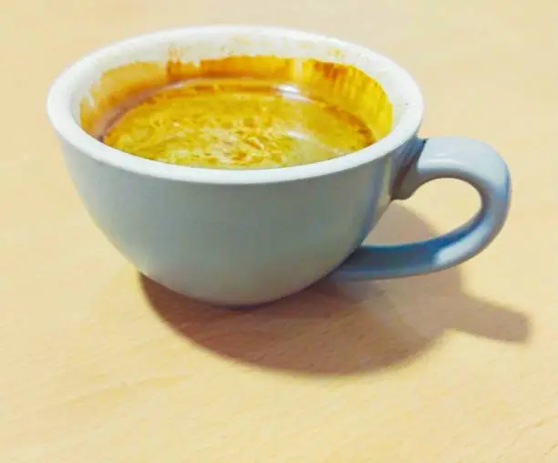 Coffee drink in a mug hotcoffee cup taza de cafe brown mocha milkcoffee beverage closeup view image stock photo.
