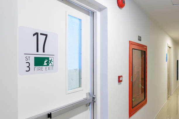 istock Fire extinguisher system on the wall with Fire Exit door sign for emergency. Stairwell fire for escape in building or apartment 1438836323