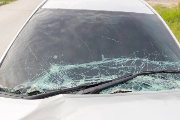 istock Broken car windshield .Crash windshield glass the broken and damaged car. Tempered glass shattered in an accident. Broken Windshield 1438837495