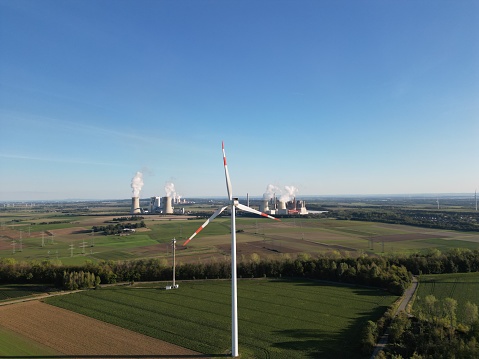 Wind turbine in North Rhine-Westphalia, with coal-fired power plants in the background.